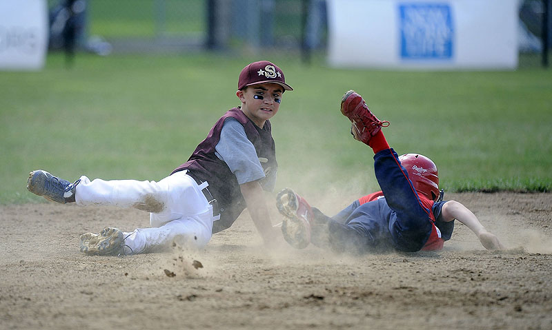 Blaze Zaniol, right, of Lincoln, R.I., dives into second base ahead of the tag by Saco’s Luke Chessie during Friday’s opening game at the Little League New England Regional in Bristol, Conn. Lincoln won, 11-2.
