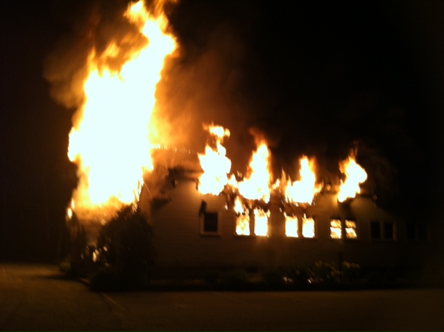 Wescustogo Hall in North Yarmouth is engulfed in flames early Friday morning.