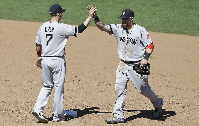 Shortstop Stephen Drew and left fielder Jonny Gomes celebrate after Wednesday’s 12-1 victory over the San Francisco Giants.