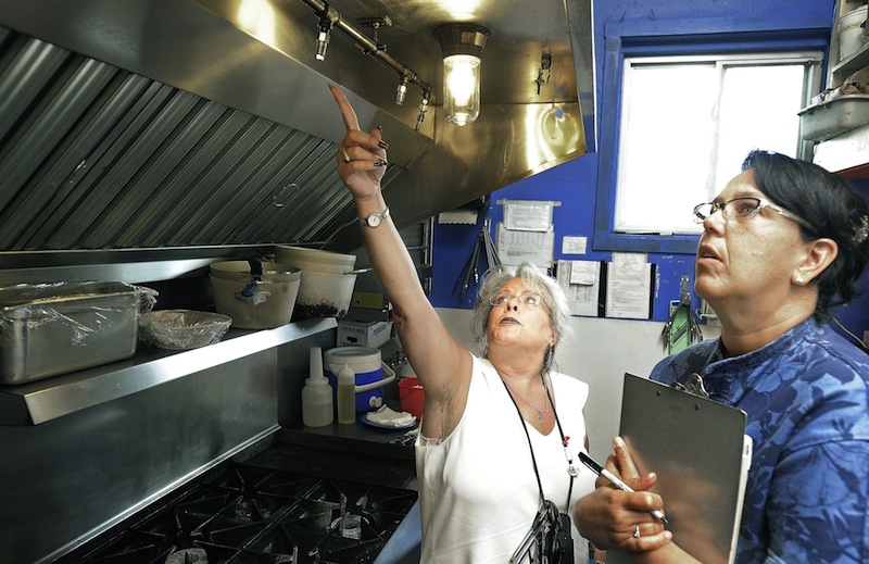 In this September 2012 file photo, Portland health inspector Michele Sturgeon goes through kitchen at El Rayo Taqueria. The city has inspected almost twice as many restaurants so far this year as it did in all of 2012, but fewer have failed inspections. The absence of Sturgeon – a strict, controversial inspector – has likely affected the numbers, as has the city's beefed up scrutiny and a falling non-compliance rate.
