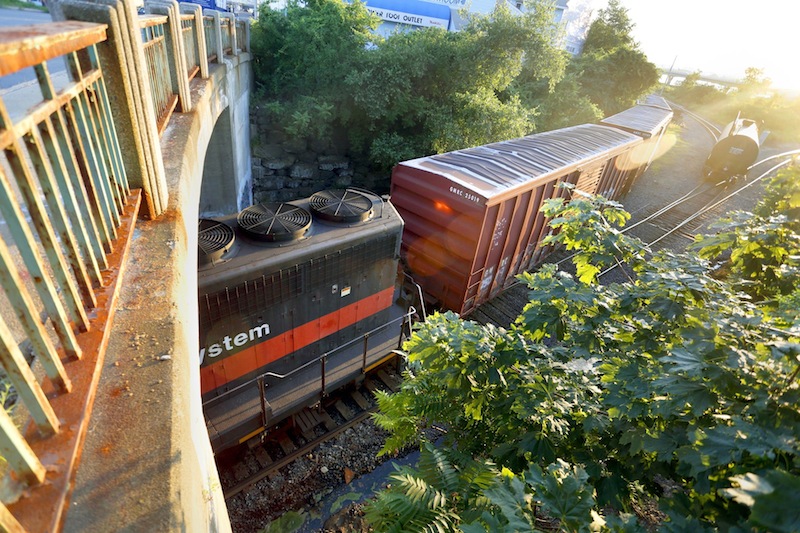 In this July 2013 file photo, a Pan Am Railways train passes under the Danforth Street Bridge at Cassidy Point in Portland. The U.S. Department of Labor has ordered Pan Am Railways to pay $50,000 in compensatory and punitive damages to an injured Waterville worker.