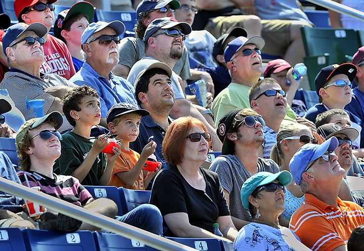 In this Wednesday, Aug. 21, 2013, fans keep an eye on a pop fly as the Portland Sea Dogs hosted the New Hampshire Fisher Cats at Hadlock Field. Despite good August numbers, the Sea Dogs experienced their lowest attendance numbers in 20 years this season.