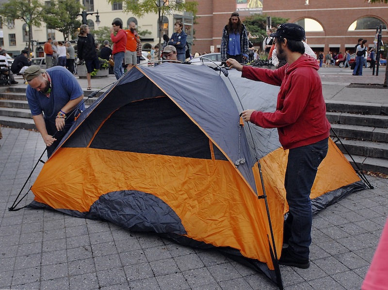 Evan McVeigh and Michael Anthony, members of Occupy Portland, set up their tent to begin an occupation of Congress Square Park in Portland on Friday, Sept. 6, 2013 in effort to raise awareness about the city's pending sale of the public space.
