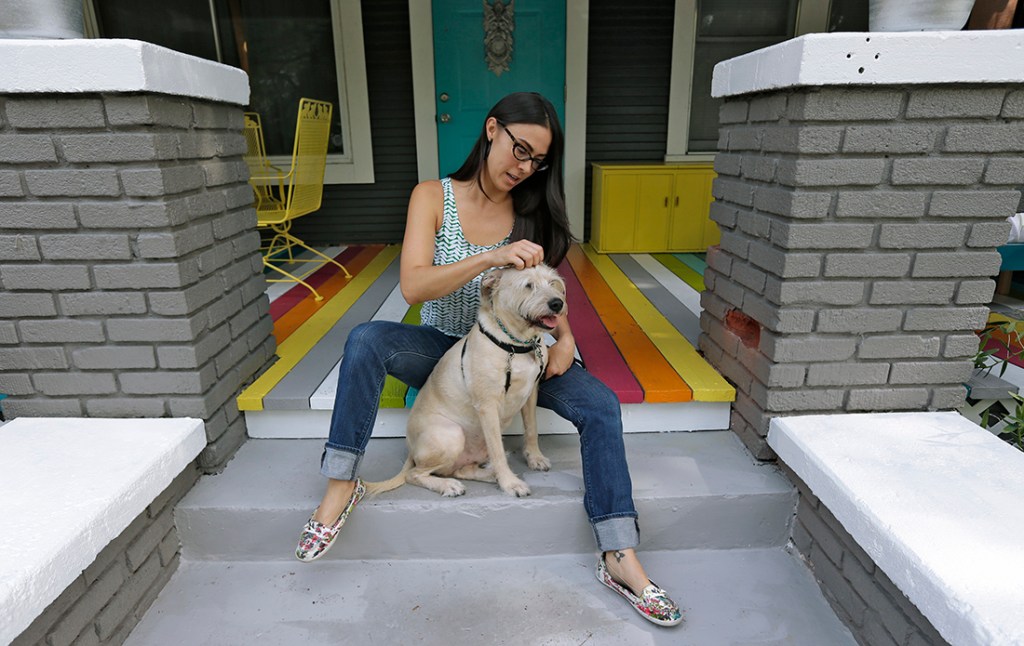 In this Wednesday, Sept. 4, 2013 photo, 32-year-old Jessi Spencer-Hammac poses with her dog Rocco, in Tampa, Fla. Decades before being diagnosed with bipolar disorder, Spencer-Hammac thought she was just moody, a restless dreamer with grand plans who had trouble finishing projects. (AP Photo/Chris O'Meara)