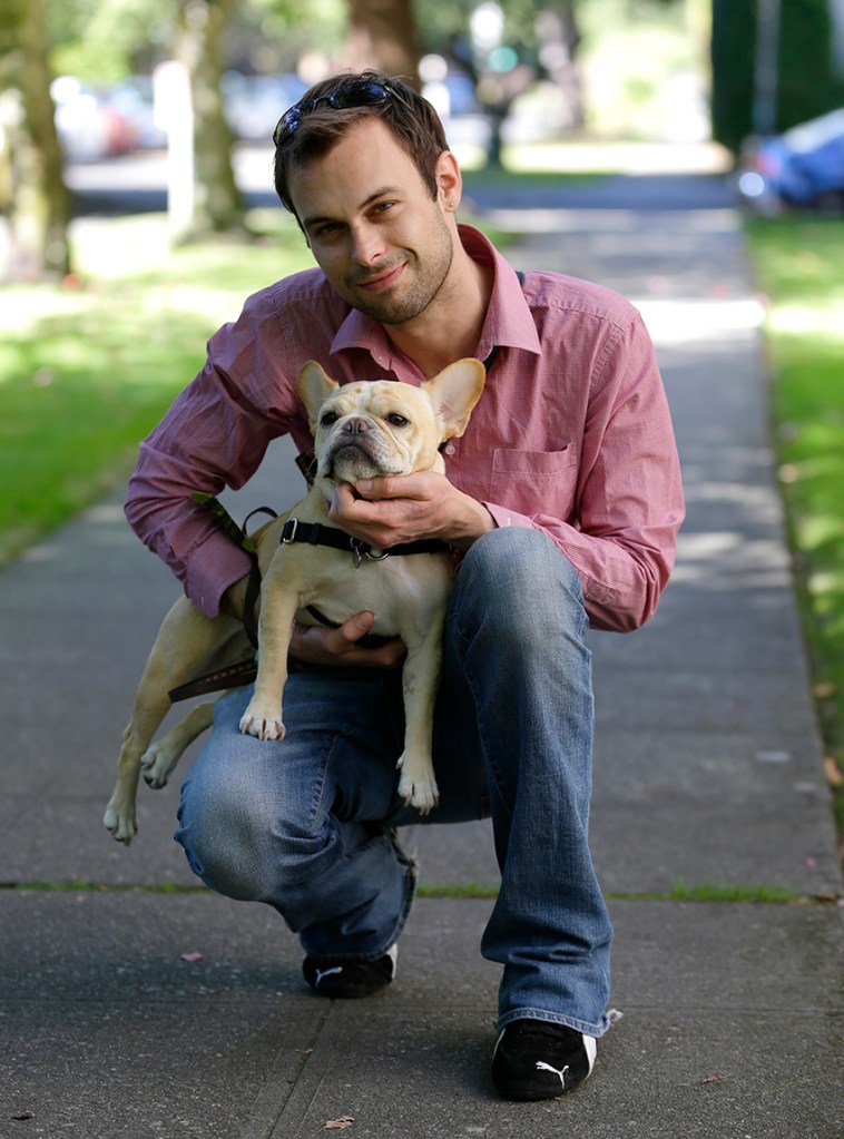 Aaron Brethorst poses for a photo while walking his dog, Moxie, in Seattle on Monday, Sept. 9, 2013. Brethorst says he doesn't have a problem with President Obama's health care reforms because he figures he’ll be able to afford quality insurance and he expects his coverage will be even better once the Affordable Care Act kicks in. (AP Photo/Ted S. Warren)