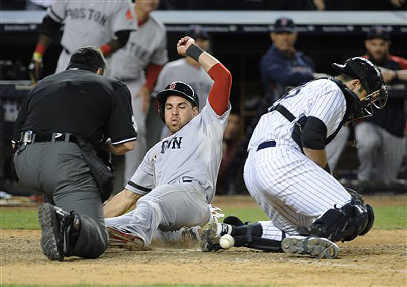 Boston center fielder Jacoby Ellsbury scores on a single by Shane Victorino on Thursday as New York Yankees catcher Austin Romine, right, cannot handle the throw. Home Plate umpire Rob Drake is at left. Ellsbury has a broken foot and will remain out of the lineup for an unspecified period.