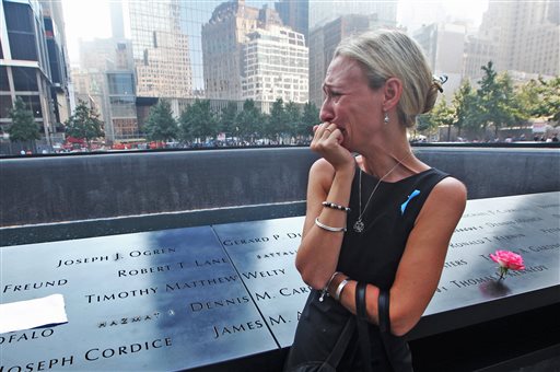 Carrie Bergonia of Pennsylvania looks over the name of her fiance, firefighter Joseph Ogren, at the 9/11 Memorial during ceremonies marking the 12th anniversary of the attacks on the World Trade Center in New York.