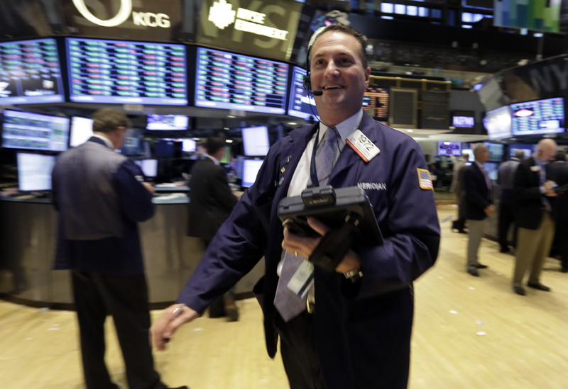 Trader Jonathan Corpina works on the floor of the New York Stock Exchange on Wednesday. The stock market hit a record high Wednesday after the Federal Reserve's surprise decision to keep its economic stimulus in place.