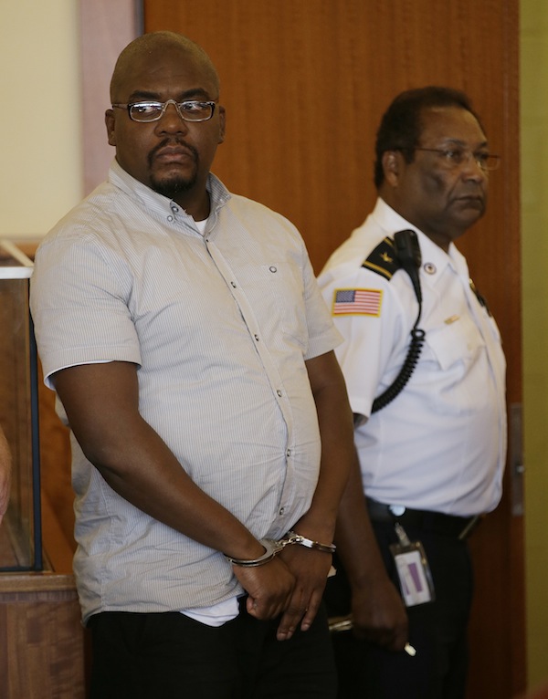 Ernest Wallace, left, an associate of former New England Patriots tight end Aaron Hernandez, looks toward his attorneys as he appears in Bristol Superior Court for a bail hearing on a charge of accessory to murder after the fact in the death of semi-professional football player Odin Lloyd in Fall River, Mass., Thursday, Sept. 26, 2013. A cash bail of $500,000 was set for Wallace. (AP Photo/Stephan Savoia)