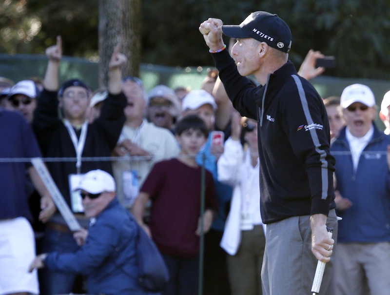 Jim Furyk pumps his fist after posting a 59, tying the PGA single round record, during the second round of the BMW Championship golf tournament at Conway Farms Golf Club in Lake Forest, Ill., on Friday.