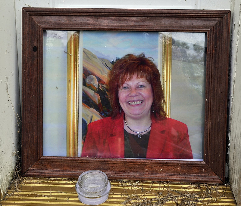 This portrait of Lynn Arsenault was among the items in a memorial at her doorstep on Tuesday, Sept. 3, 2013. Police have charged Todd Gilday, 44, with her murder. Arsenault's son Mathew Day was also shot and injured in the incident at the Waldo Avenue house that Arsenault owned.