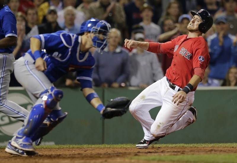 Will Middlebrooks, right, heads home to score on a single by Dustin Pedroia in the eighth inning.