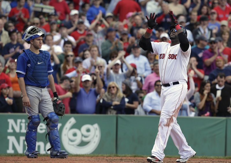 Boston Red Sox's David Ortiz, right, celebrates his home run off a pitch by Toronto Blue Jays' R.A. Dickey as Toronto Blue Jays' Josh Thole, left, looks on in the sixth inning of a baseball game at Fenway Park, in Boston, Sunday, Sept. 22, 2013. (AP Photo/Steven Senne)
