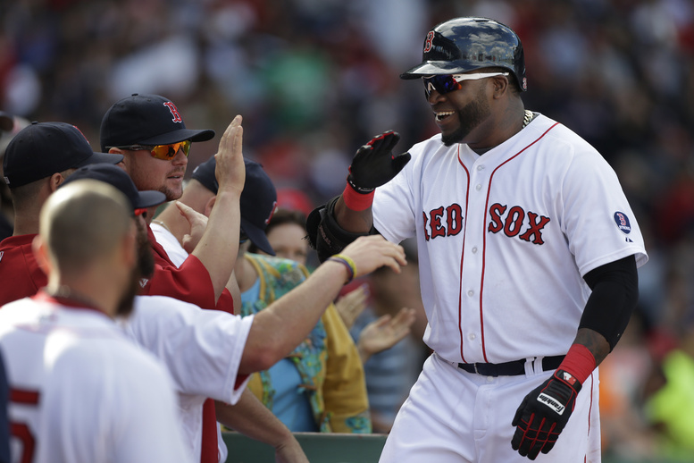 Boston Red Sox's David Ortiz, right, is welcomed to the dugout after hitting a home run in Sunday's game at Fenway Park in Boston. The Red Sox are headed to their first postseason in four years.
