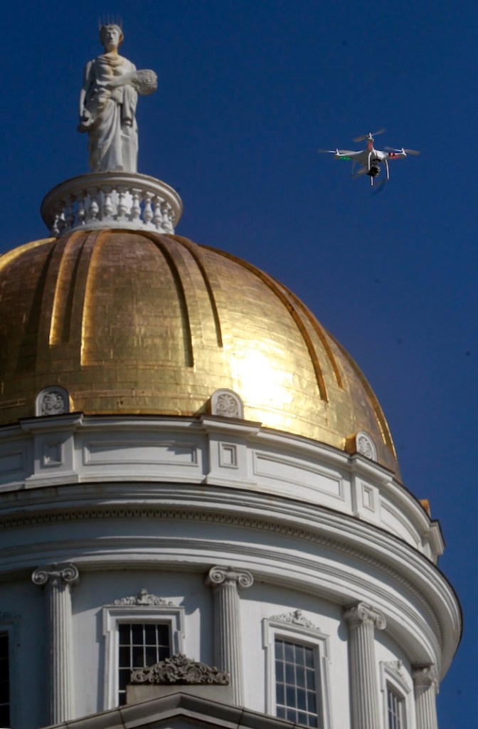 A drone is flown over the Statehouse in a demonstration by the Vermont chapter of the American Civil Liberties Union on Tuesday, Sept. 17, 2013 in Montpelier, Vt. Executive director Allen Gilbert says the ACLU is going to ask the Legislature to regulate surveillance of private citizens by state, local and federal law enforcement agencies. (AP Photo/Toby Talbot)