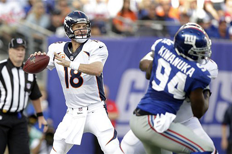 Denver Broncos quarterback Peyton Manning (18) throws a pass during the first half against the New York Giants Sunday in East Rutherford, N.J.