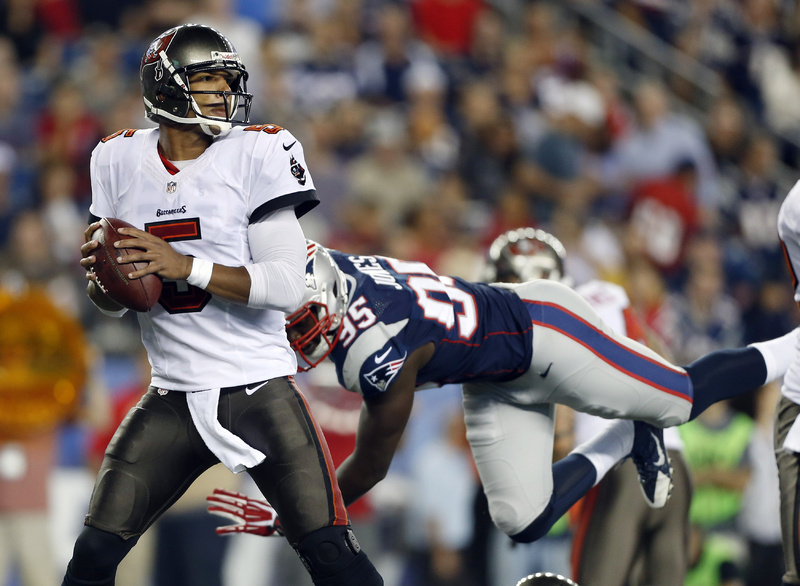 Tampa Bay Buccaneers quarterback Josh Freeman looks to pass against the rush of New England Patriots defensive end Chandler Jones in a preseason game in August. The two teams face each other Sunday.