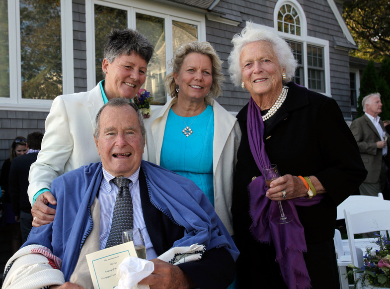 Former President George H.W. Bush and former first lady Barbara Bush, right, pose for photos after the wedding of longtime friends Helen Thorgalsen, center, and Bonnie Clement, in Kennebunkport on Saturday.