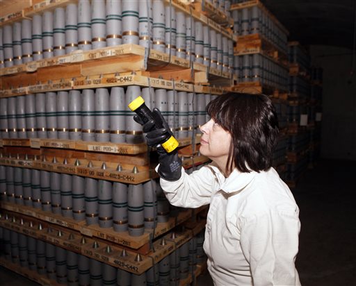 In this January 2010 photo Debra Michaels, chemical operations manager, inspects mustard agent shells in one of the bunkers at the Pueblo Army Chemical Storage facility in Pueblo, Colo.