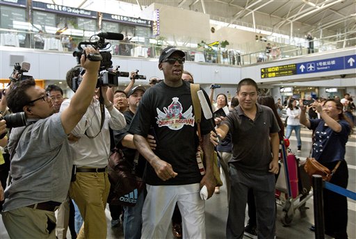Journalists surround basketball star Dennis Rodman at the departure hall of Beijing Capital International Airport on Tuesday. Rodman is heading to North Korea for the second time this year for what he says is a friendly visit to his friend, the communist nation's leader, Kim Jong Un.