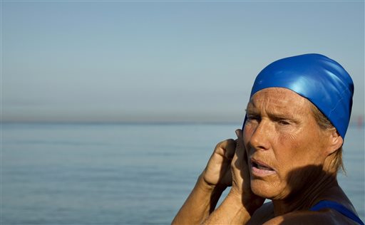U.S. swimmer Diana Nyad, 64, adjusts her swimming cap before her swim to Florida from Havana, Cuba, Saturday, Aug. 31, 2013. Endurance athlete Nyad launched another bid Saturday to set an open-water record by swimming from Havana to the Florida Keys without a protective shark cage.