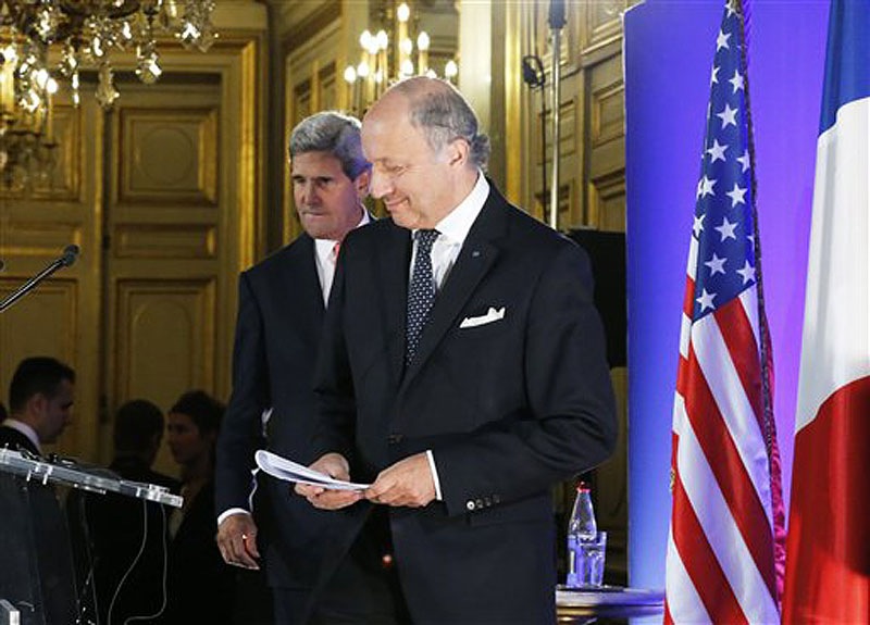 U.S. Secretary of State John Kerry, left, and France's Foreign Minister Laurent Fabius arrive for their meeting at the Quai d' Orsay in Paris on Saturday. Kerry traveled to Europe to court international support for a possible strike on the Syrian regime for its alleged use of chemical weapons while making calls back home to lobby Congress, where the action faces an uphill battle.