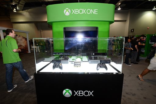 FILE - This Aug. 28, 2013 file photo shows a Microsoft Xbox One console at GameStop Expo, in Las Vegas. During a presentation at the GameStop Expo to promote the upcoming Xbox One console last week, a no-frills approach is exactly what Microsoft employed when confronted with a convention room full of passionate gamers. There were no flashy videos, sensational demonstrations or celebrity appearances. (Photo by Al Powers/Invision/AP, File)