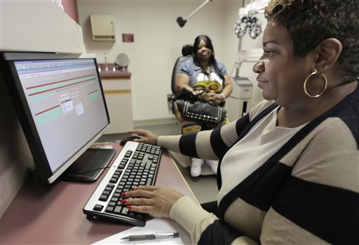 Jacqueline Saulsberry, a service coordinator at the Illinois Eye Institute, gathers information from patient Shameka Lewis-Coolidge during an appointment in Chicago. The institute, which will help with Obamacare enrollment in the Chicago area, plans to train a dozen staffers for the task.