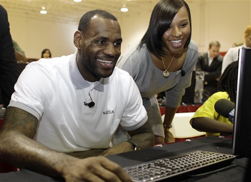 Miami Heat basketball player LeBron James sits with his girlfriend, Savannah Brinson, at a new computer during a charity event in Miami in March 2011. James married Brinson at the posh Grand Del Mar Hotel in San Diego on Saturday.