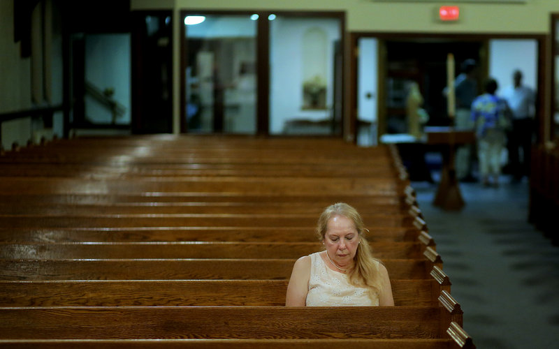 Determined to be the last person to leave the church, Sheila Duane of South Portland sits in her pew long after the final Mass at St. John the Evangelist Catholic Church in South Portland ended Wednesday night. Duane has been a parishioner at the church for 40 years, and struggled emotionally with its closing.