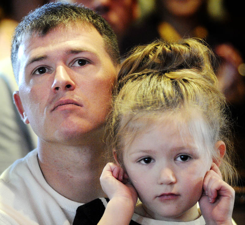 Travis Bentley holds his daughter, Reese, Tuesday September 17, 2013 during the first graduation ceremony for veterans at the Co-Occuring Disorders Court and Veterans Court at Kennebec County Superior Court in Augusta. entley, a Marine combat veteran of Iraq, graduated with Daniel Andrews, an Army combat veteran of Iraq.