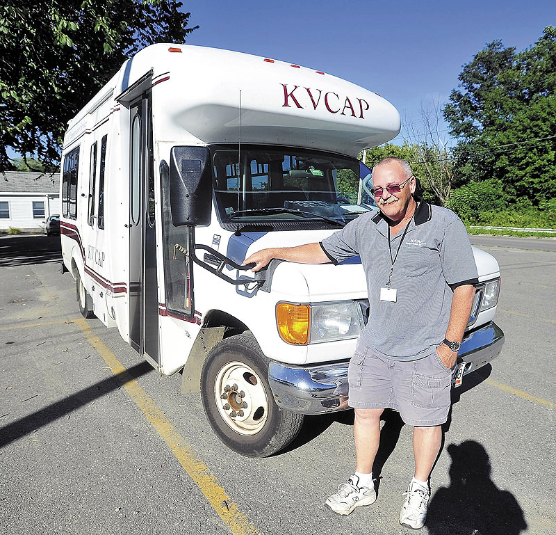 Mark Goggins stands next to his KVCAP bus in Waterville on Friday. KVCAP used to provide between 900 and 1,000 rides a day to MaineCare patients.