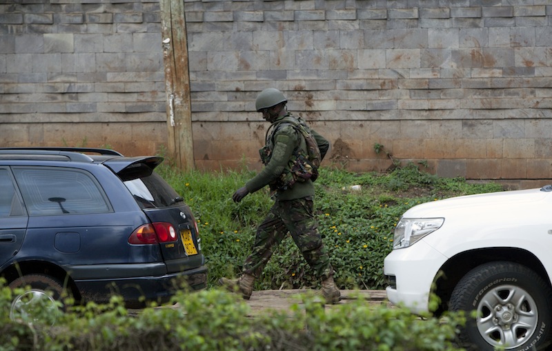 A Kenyan security forces soldier walks towards the Westgate Mall in Nairobi, Kenya Tuesday Sept. 24 2013. Gunfire has erupted sporadically on the fourth day of a hostage siege. Security forces have been attempting to rescue an unknown number of hostages inside the mall held by al-Qaida-linked terrorists.