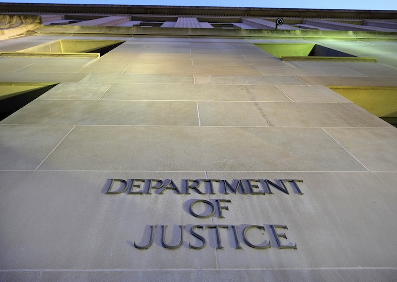 In this May 14, 2013, file photo, the Department of Justice headquarters building in Washington is photographed early in the morning. Former FBI explosives expert Donald Sachtleben of Carmel, Ind., said Monday, Sept. 23, he will plead guilty to revealing secret information for an Associated Press story about a U.S. intelligence operation in Yemen in 2012. The story led to a leaks investigation and the seizure of AP phone records in the government's search for the information's source. (AP Photo/J. David Ake, File)
