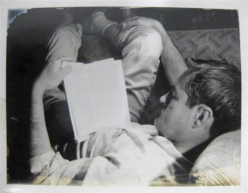 In this circa 1961 file photo provided by the New York Public Library, a curled-up Timothy Leary reads a book.