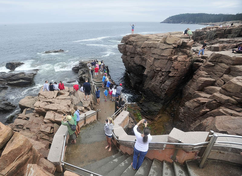 Crowds of people gather around Thunder Hole at Acadia National Park in Bar Harbor in July 2013. The park may need to close at the height of the fall foliage season if congress can't reach a deal on federal spending.