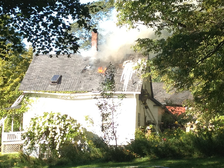 Firefighters battle a blaze at a home near the intersection of Webb Road and Route 126 in Pittston Friday afternoon. Investigators say the fire was intentionally set, and two local teenagers are considered suspects.