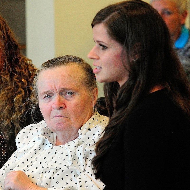 Jeannette Bancroft, 74, of New Gloucester, left, listens as Lauren Hurley, of Creative Work Systems, testifies about the problems Bancroft, who uses a wheelchair, has had getting rides to the Morrison Center in Scarborough, during a meeting of the Legislature's Health and Human Services committee on Wednesday, Sept. 11, 2013, in the Cross Building in Augusta.