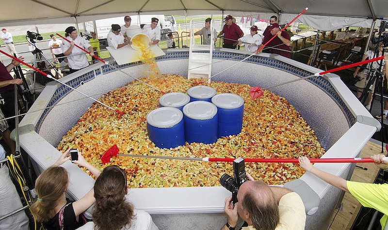 This Monday, Sept. 2, 2013 photo released on the University of Massachusetts, Amherst media relations website shows a fruit salad prepared on campus, and weighing more than 15,000 pounds. A Guinness World Records representative certified the big salad as a record. The school has held a food event that has become an annual tradition. Recent years have featured record-breaking seafood stews and stir fries. (AP Photo/University of Massachusetts, Amherst)