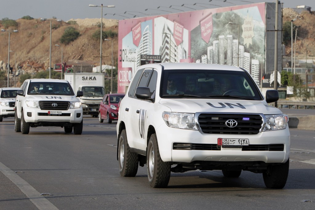 The convoy of a U.N. team of weapons inspectors arrive at the airport in Beirut on Monday to catch a plane to Syria, where they will oversee chemical weapons destruction.