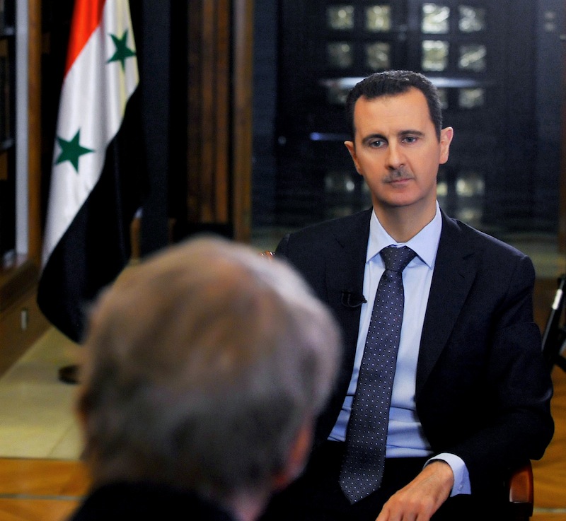 In this Sunday, Sept. 8, 2013 photo released by the Syrian official news agency SANA, PBS host Charlie Rose, foreground, interviews Syrian President Bashar Assad at the presidential palace in Damascus, Syria. In an interview broadcast Monday, Sept. 9, 2013 on "CBS This Morning," Assad denied responsibility and accused the Obama administration of spreading lies without providing a "single shred of evidence," he warned that air strikes against his nation could bring retaliation. (AP Photo/SANA)