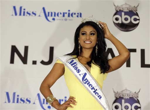 Miss America Nina Davuluri poses for photographers following her crowning in Atlantic City, N.J., on Sunday. For some who observe the progress of people of color in the U.S., Davaluri's victory in the pageant shows that Indian-Americans can become icons even in parts of mainstream American culture that once seemed closed.