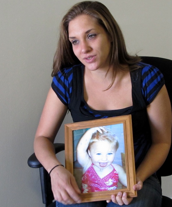 Trista Reynolds, 25, holds a photo of her 20-month-old daughter, Ayla Reynolds, during an interview with the Associated Press in Westbrook, Maine, Tuesday, Sept. 17, 2013. Reynolds, whose daughter went missing in December of 2011, says she's going to release more information she's been told by investigations in hopes of calling attention to the case and bringing it to a resolution. (AP Photo/Clarke Canfield)