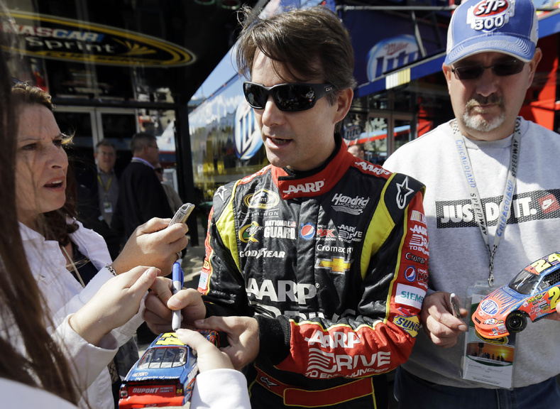 Driver Jeff Gordon signs autographs for fans as he walks to his garage during practice for Sunday's NASCAR Sprint Cup Series auto race at Chicagoland Speedway in Joliet, Ill., on Friday. NASCAR added him to the Chase field.