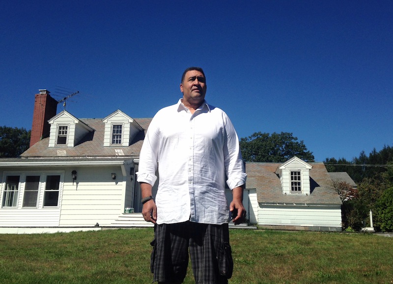 Former NFL offensive lineman Brian Holloway stands in front of his rural vacation home Wednesday, Sept. 18, 2013, in Stephentown, N.Y. Holloway’s rural vacation home was trashed during a Labor Day weekend party attended by an estimated 200 to 400 teenagers. Holloway said the partiers caused at least $20,000 in damage, breaking windows and doors, punching holes in walls and spraying graffiti. He saw the whole thing unfold live on Twitter _ and now he’s using the teens’ own posts to reveal their identities and to try to set them on a better path. (AP Photo/Michael Hill)