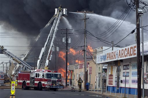 Firefighters battle a fire on the Seaside Heights, N.J. boardwalk on Thursday. The fire started in the vicinity of an ice cream shop and burned several blocks of boardwalk and businesses in a town that was still rebuilding from damage caused by Superstorm Sandy.