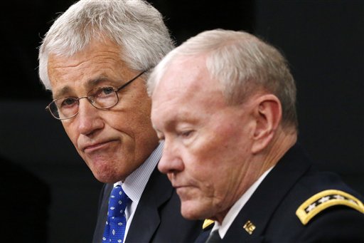 Defense Secretary Chuck Hagel, left, and Chairman of the Joint Chiefs of Staff Gen. Martin Dempsey speak during a press conference on military base security on Wednesday at the Pentagon.