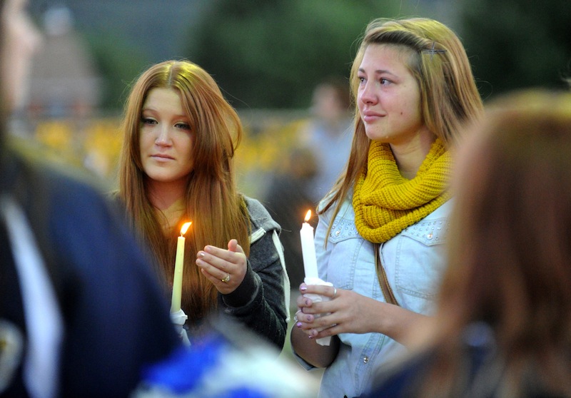 Megan Ridgell, left, and Colette Turner take part in a candlelight vigil in honor of Richard Michael Ridgell, Megan's father, at Jaycee Park in Westminster, Md. Tuesday, Sept. 17, 2013. Ridgell was killed in Monday's shooting at the Navy Yard in Washington. (AP Photo/Carroll County Times, Dave Munch) #forsale