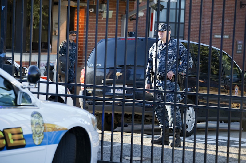 Members of the Navy guard inside of the closed Washington Navy Yard in Washington, on Tuesday, Sept. 17, 2013, the day after a gunman launched an attack inside the Washington Navy Yard on Monday, spraying gunfire on office workers in the cafeteria and in the hallways at the heavily secured military installation in the heart of the nation's capital. Only essential personnel were being permitted inside, according the authorities. (AP Photo/Jacquelyn Martin)