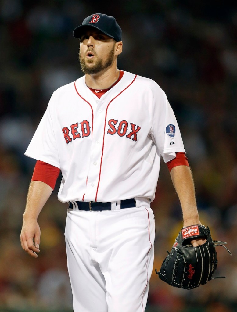Red Sox pitcher John Lackey walks to the dug out after retiring the Baltimore Orioles in the third inning Thursday.